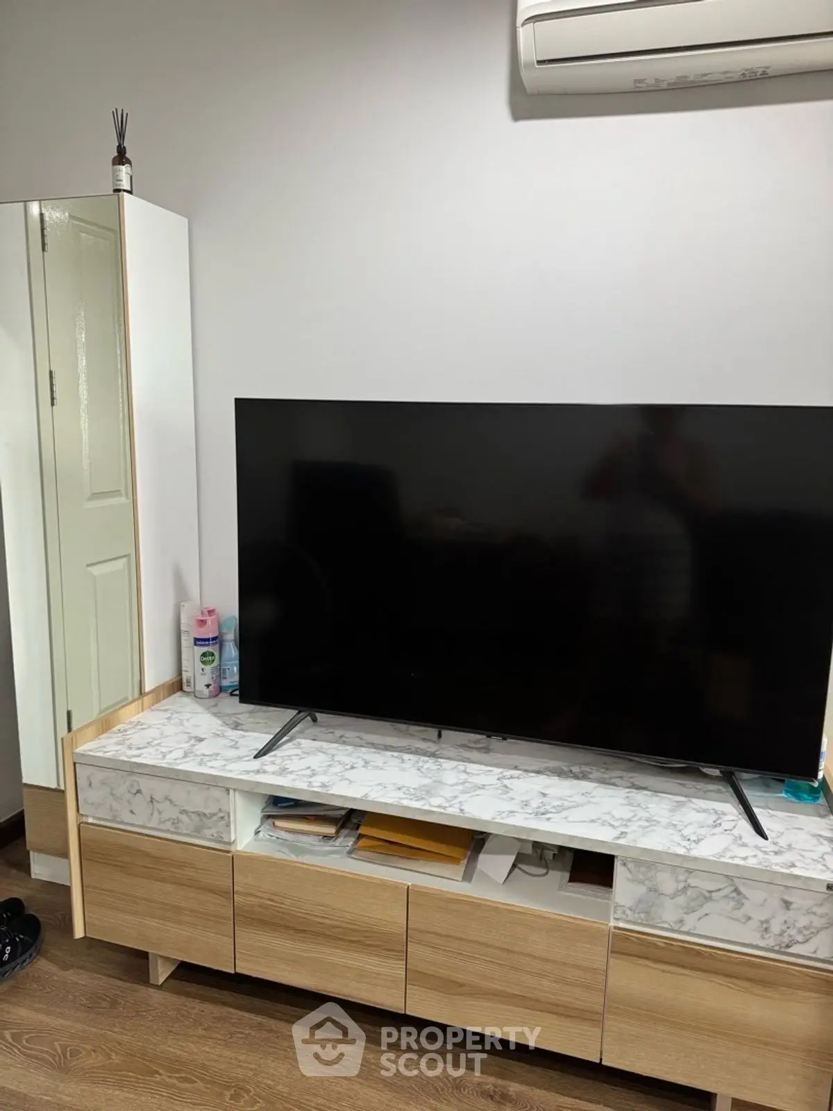 Modern living room with sleek TV setup and stylish wooden furniture