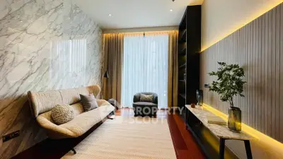 Luxurious modern living room with elegant marble wall and cozy seating area.