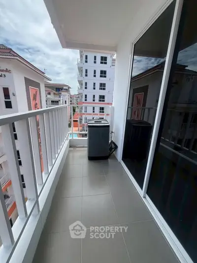 Spacious balcony with modern washing machine and city view