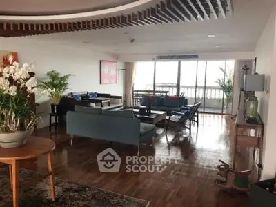 Spacious living room with elegant decor and large windows offering natural light.