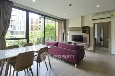 Modern living room with large windows and stylish furniture in a contemporary apartment.