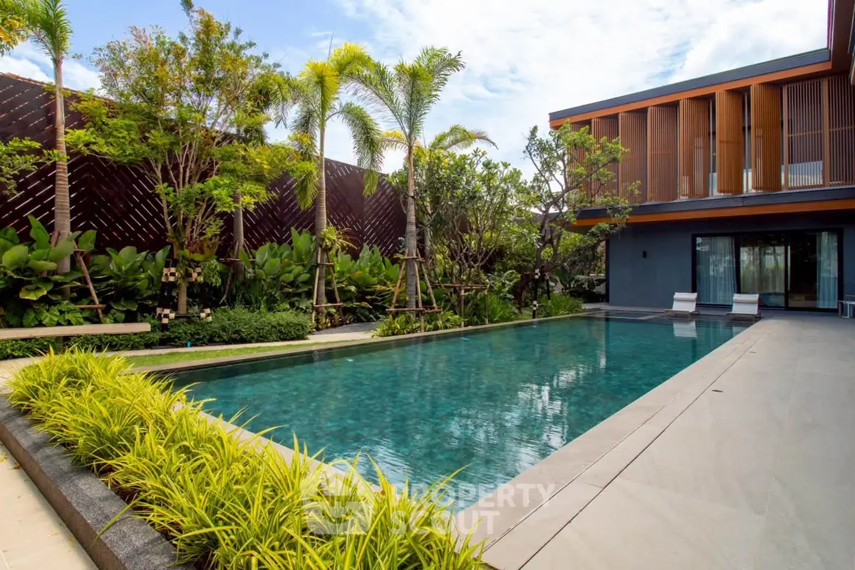 Luxurious modern villa with private pool and lush garden, perfect for relaxation and entertainment.