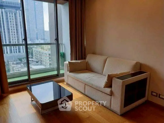 Modern living room with city view, featuring a cozy sofa and sleek coffee table, perfect for urban living.