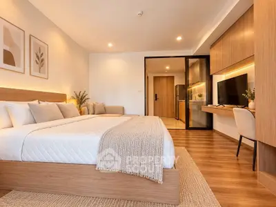 Spacious modern bedroom with cozy decor and wooden flooring
