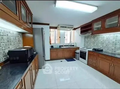 Spacious kitchen with modern appliances and stylish cabinetry in a well-lit setting.