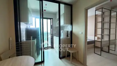 Modern apartment with glass-enclosed kitchen and bright living space