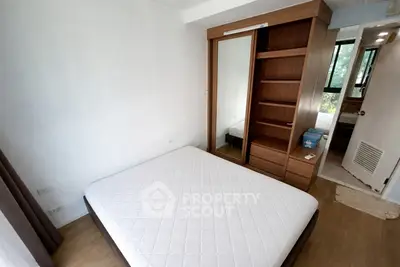 Cozy bedroom with wooden wardrobe and large window view