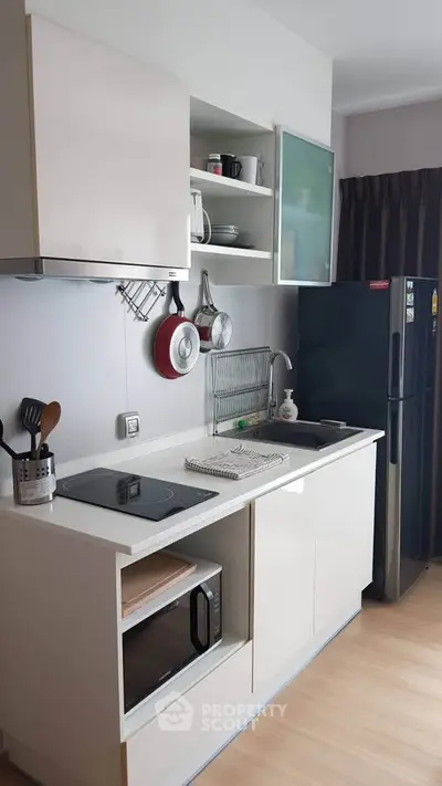 Modern compact kitchen with sleek cabinetry and appliances