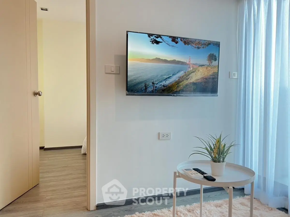 Modern living room with wall-mounted TV and stylish decor