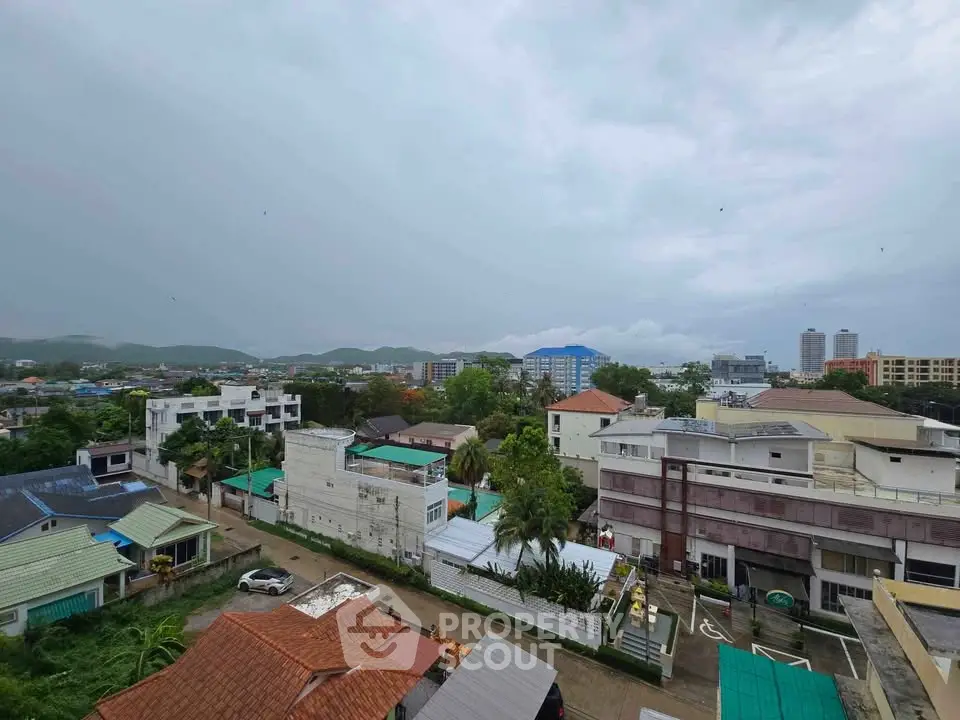 Scenic cityscape view from a high-rise building showcasing urban and natural landscapes.
