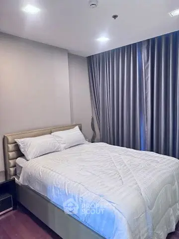 Cozy bedroom with modern decor and plush bedding in a stylish apartment.