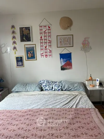 Cozy bedroom with artistic wall decor and comfortable bedding