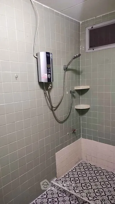 Simple bathroom with shower and patterned tile flooring