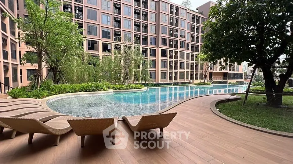 Luxurious apartment complex with stunning pool and lush greenery
