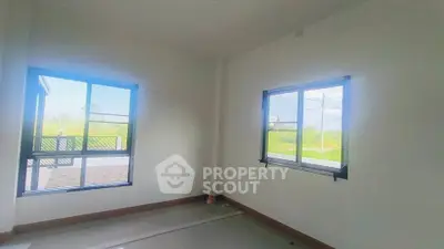 Bright room with large windows and outdoor view, perfect for customization.