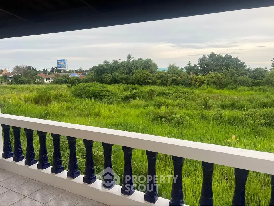 Charming balcony with lush green view, perfect for relaxation and enjoying nature's tranquility.