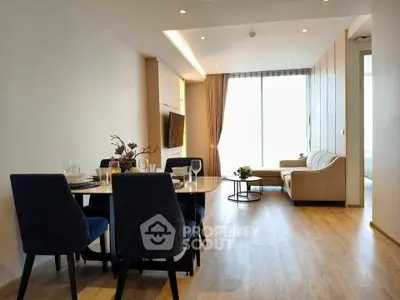 Modern living room with elegant dining area and natural light