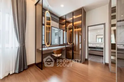 Elegant modern bedroom with stylish mirrored wardrobe and wooden flooring
