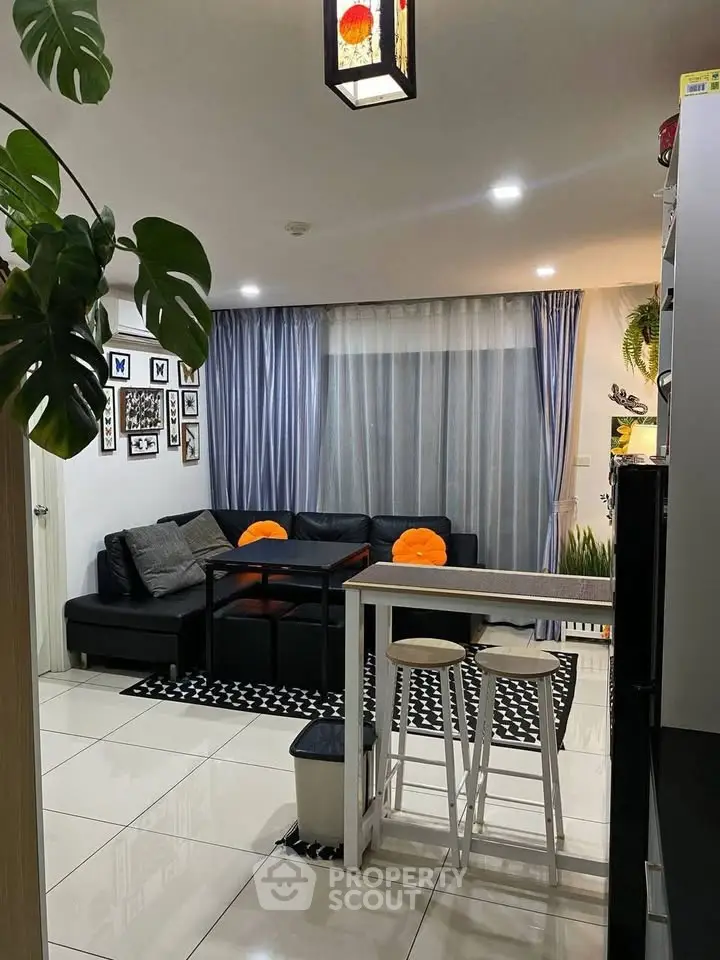 Modern living room with stylish decor and cozy seating area, perfect for relaxation.