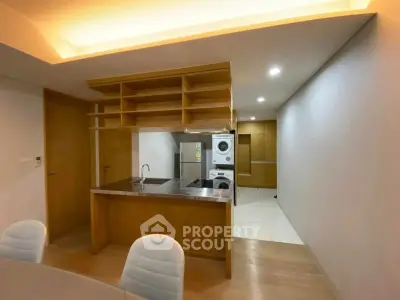 Modern kitchen with sleek cabinetry and built-in appliances in a contemporary apartment.