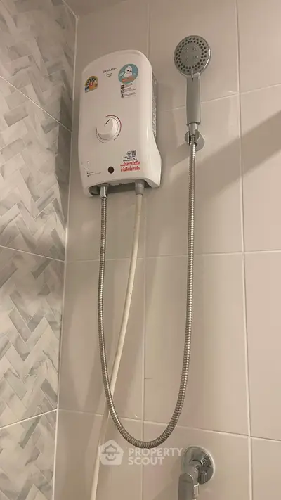 Modern bathroom with sleek shower unit and stylish tile design.