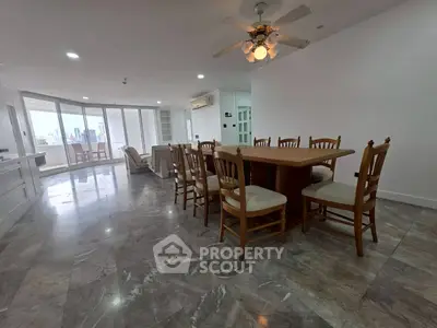 Spacious open-plan living and dining area with city view, featuring elegant marble flooring and ceiling fan.