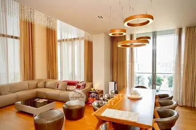 Spacious modern living room with elegant lighting and large windows.