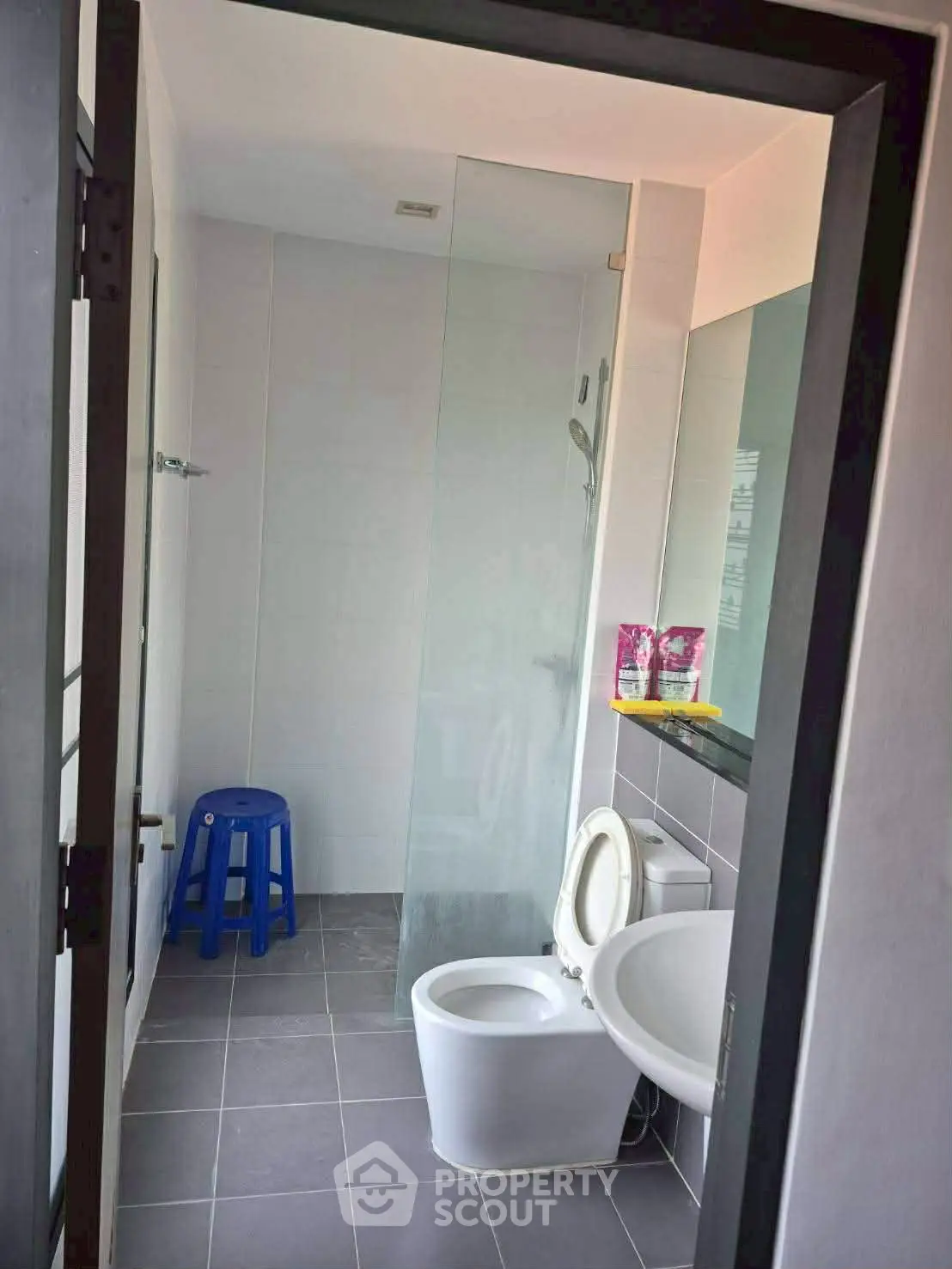 Modern bathroom with glass shower and sleek fixtures in a contemporary home.