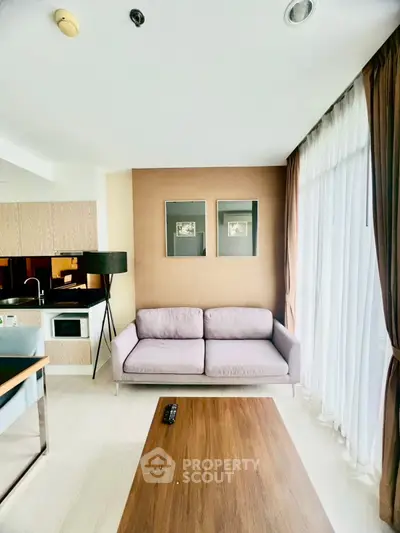 Modern living room with cozy sofa and natural light in stylish apartment.