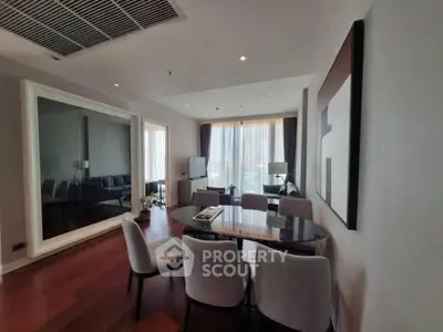 Spacious modern living room with elegant dining area and large mirror