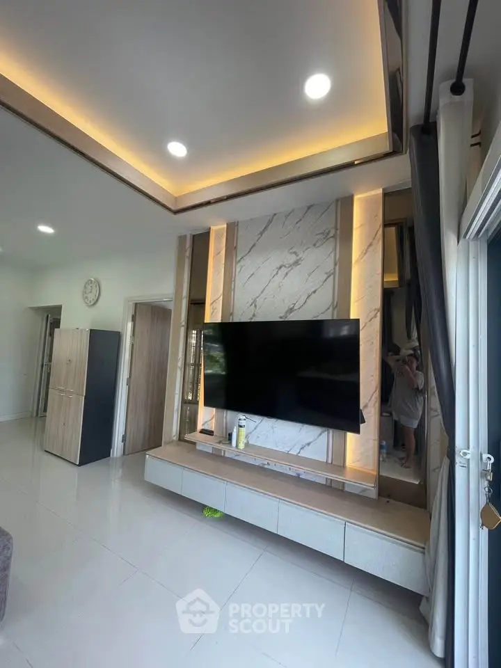 Modern living room with stylish TV setup and elegant lighting