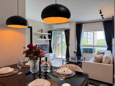 Modern living room with elegant decor, large windows, and stylish lighting in a contemporary apartment.