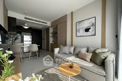 Modern living room with stylish decor and open kitchen layout in a contemporary apartment.