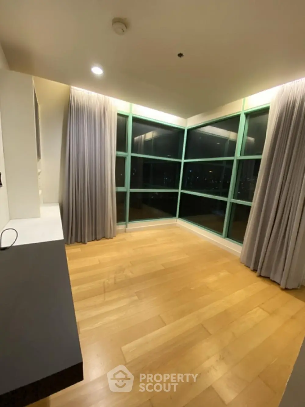 Spacious corner unit with floor-to-ceiling windows and elegant hardwood floors.