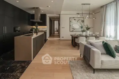 Luxurious open-plan living room and kitchen with modern decor and elegant dining area.