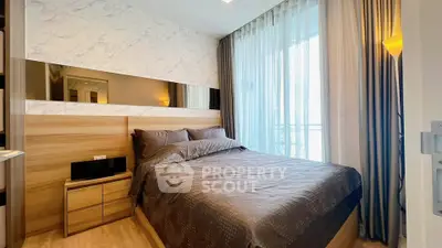 Modern bedroom with stylish decor and large window for natural light