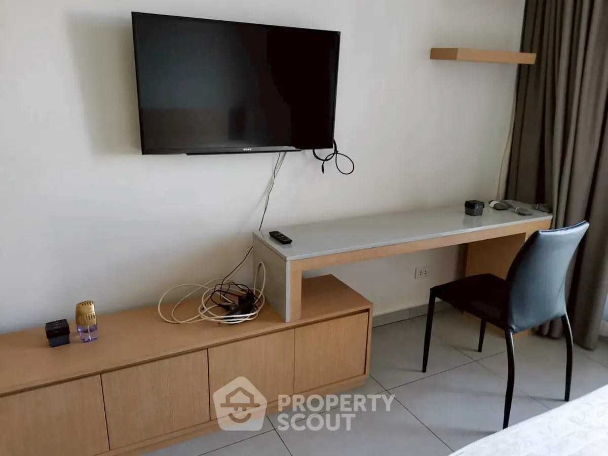 Modern living room with wall-mounted TV and sleek furniture design
