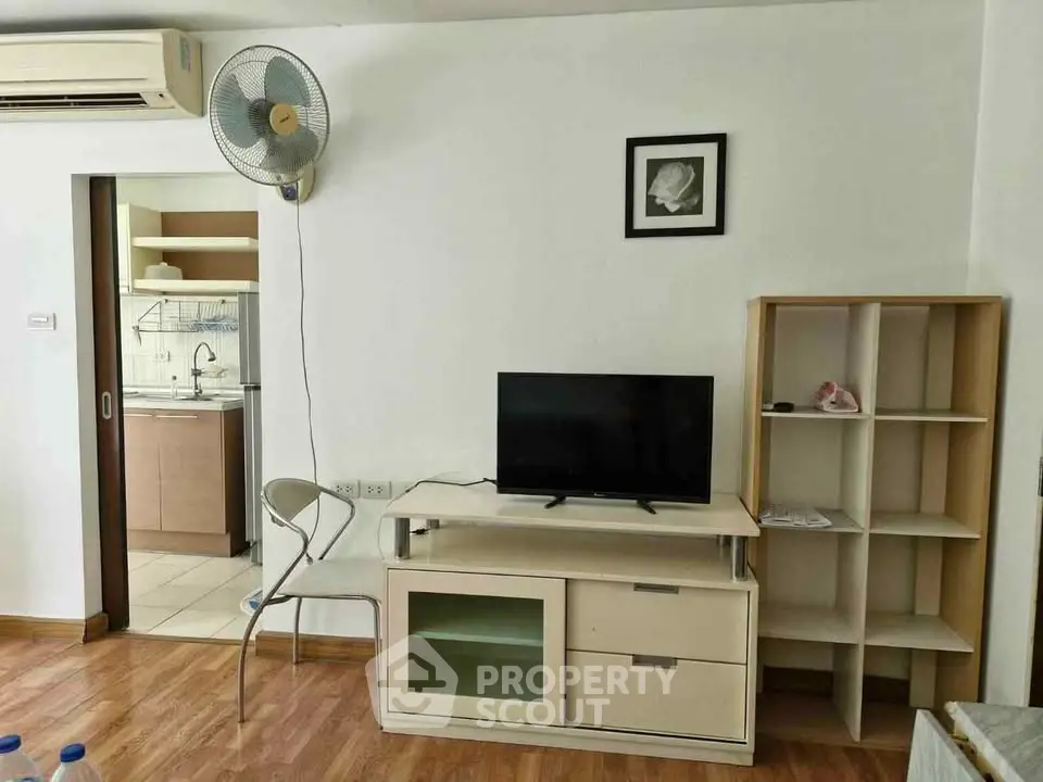Cozy living room with modern furniture and open kitchen layout, perfect for urban living.