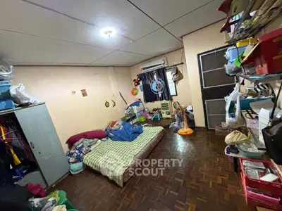 Cozy bedroom with parquet flooring and ample storage space, featuring a comfortable bed and air conditioning.