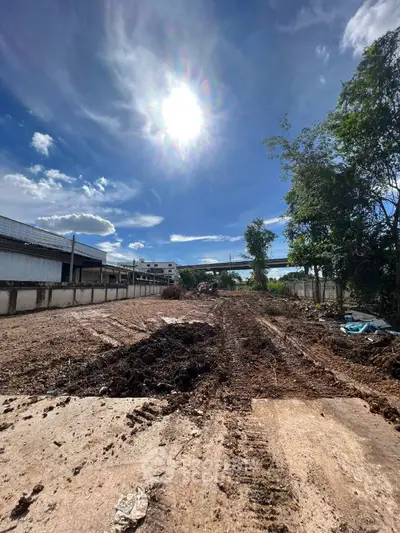 Spacious land plot under clear blue sky, ideal for development opportunities.
