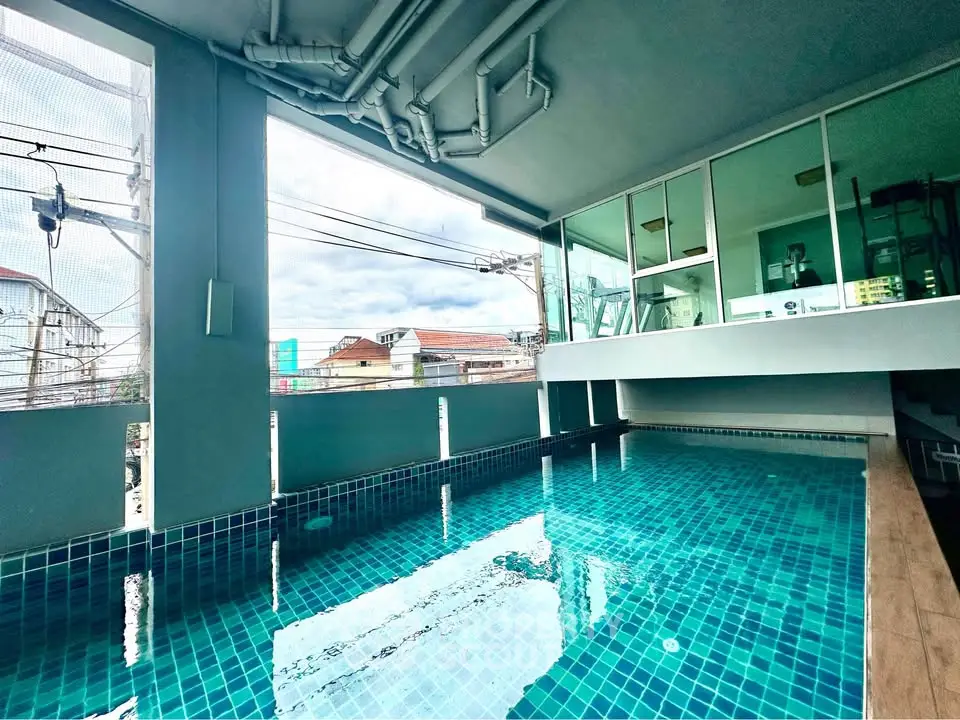 Modern indoor pool with city view in contemporary building