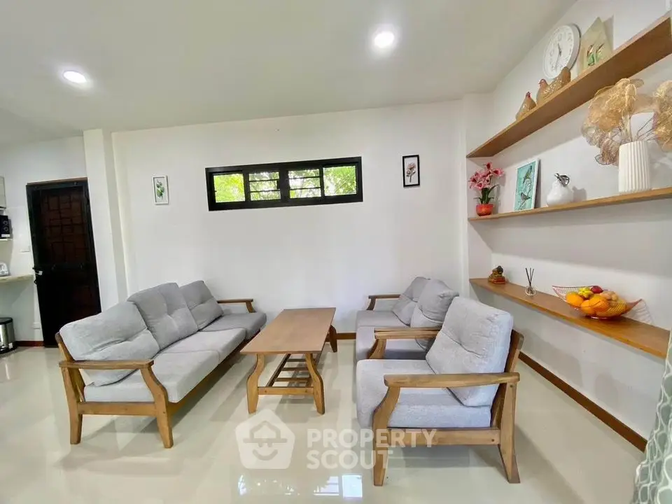 Charming living room with modern wooden furniture and decorative shelving.