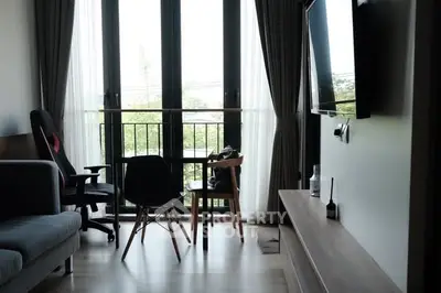 Modern living room with balcony view and stylish furniture