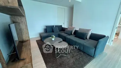 Modern living room with sleek furniture and TV setup, perfect for relaxation.