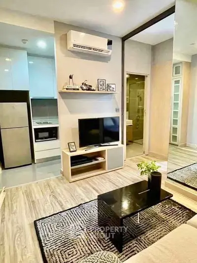 Modern living room with sleek design, featuring air conditioning, TV, and stylish decor.