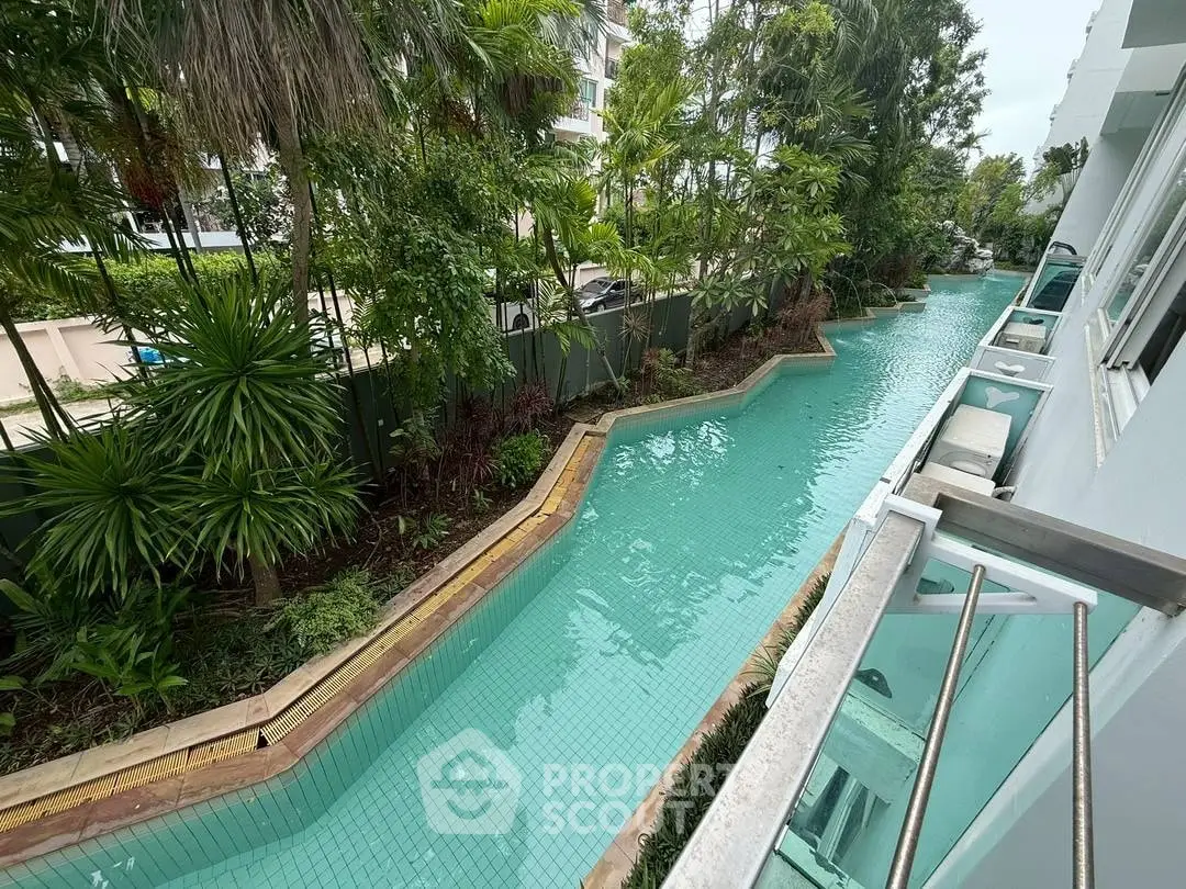 Luxurious poolside view with lush greenery and modern architecture.