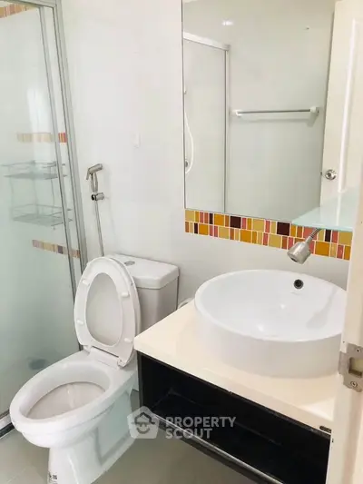 Modern bathroom with glass shower and stylish sink in a contemporary apartment.