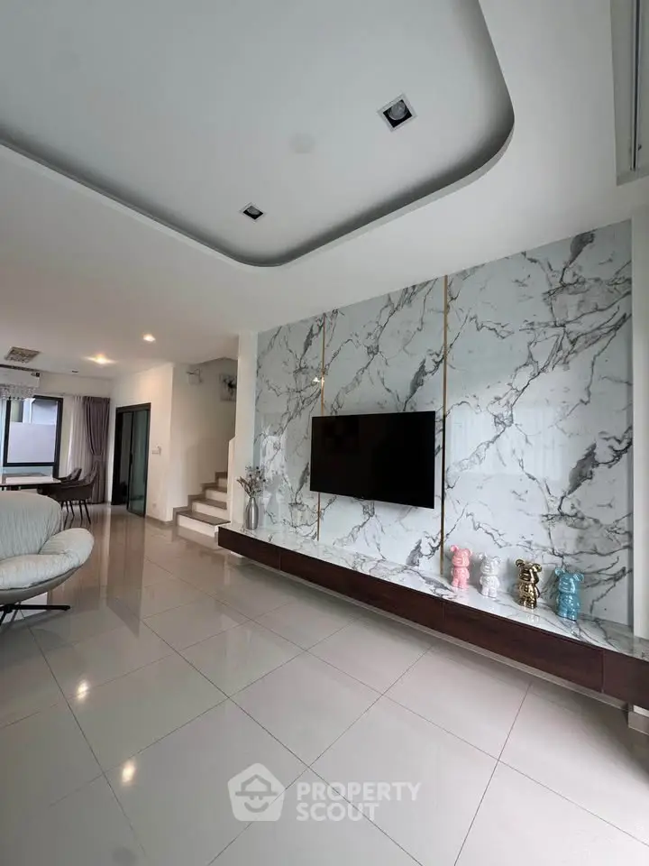 Luxurious modern living room with marble accent wall and sleek TV setup