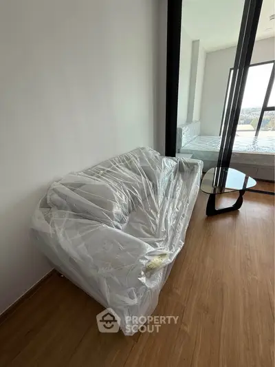 Modern apartment with a cozy living area and stylish furniture, featuring a scenic view.