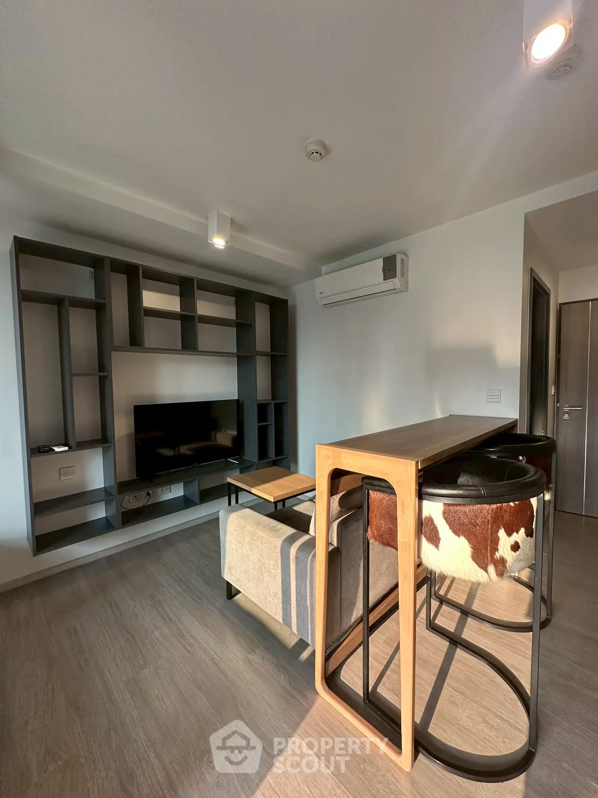 Modern living room with stylish furniture and built-in shelving unit